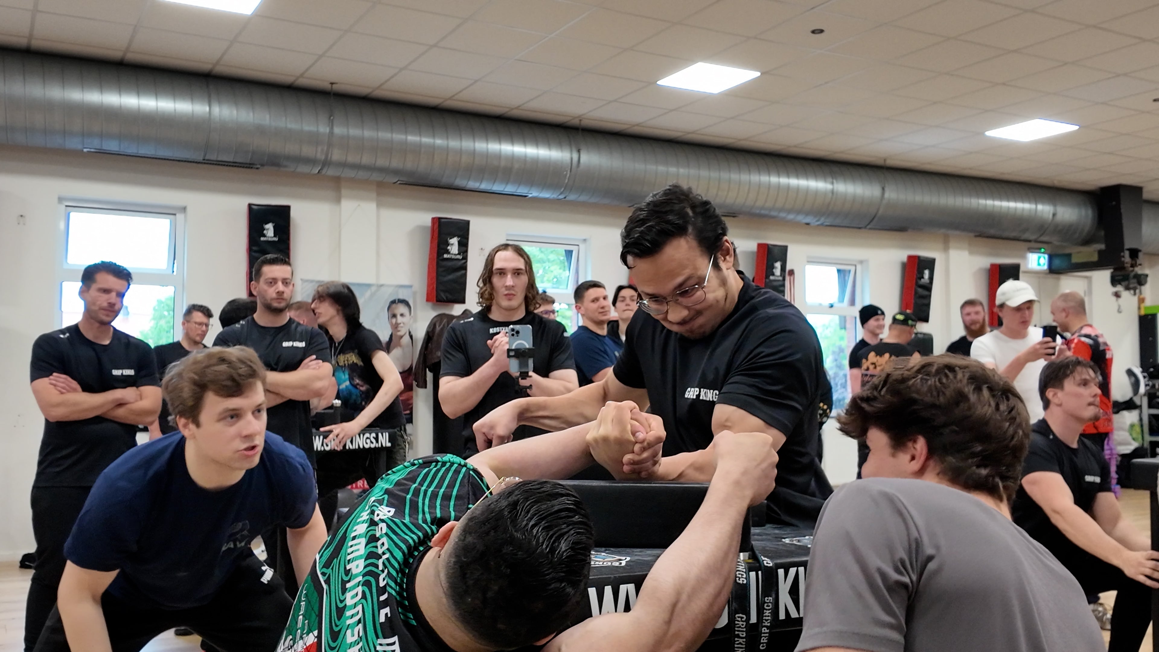 an armwrestling match with many people watching